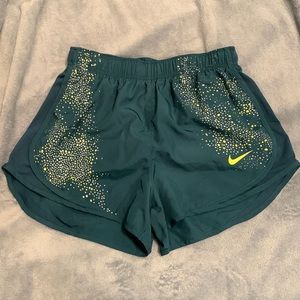 Blue Nike shorts with grey and yellow pattern